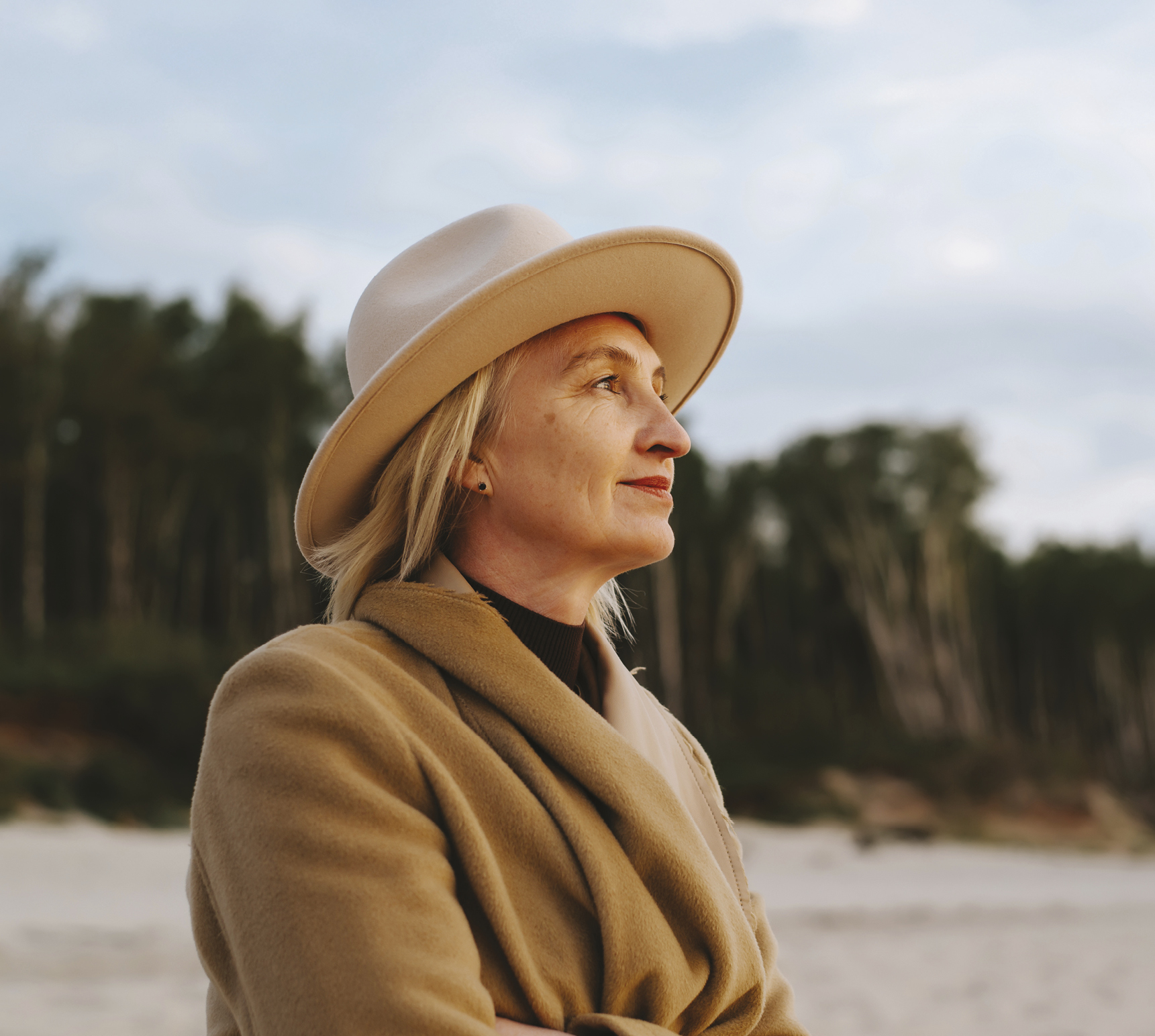 Image of a hypothetical female patient wearing a sunhat in a beach setting